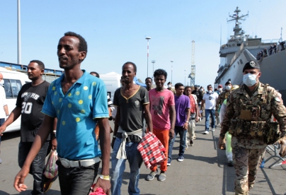 Immigrants part of a group of more than 1.400 people receive first aid after they disembarked from Italian military ship "San Giusto" on August 5, 2014 in the port of Salerno, southern Italy, following Mare Nostrum rescue operations at sea. The Italian navy said Monday it had rescued over 2,700 migrants from boats attempting to cross the Mediterranean from North Africa over the weekend, and recovered two bodies off the coast of Libya. AFP PHOTO / ROBERTA BASILE (Photo credit should read ROBERTA BASILE/AFP/Getty Images)